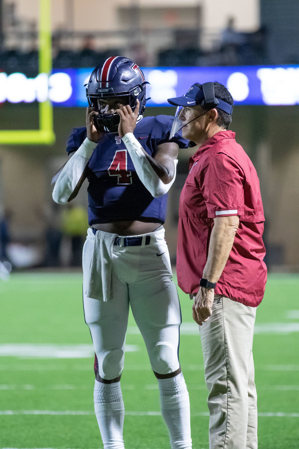 Tompkins senior quarterback Jalen Milroe, left, and Tompkins head coach Todd McVey talk during a game earlier this season at Legacy Stadium. Milroe was named District 19-6A’s Most Valuable Player and McVey was named the district’s Coach of the Year.